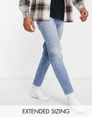 ASOS DESIGN tapered jeans in tinted mid wash blue