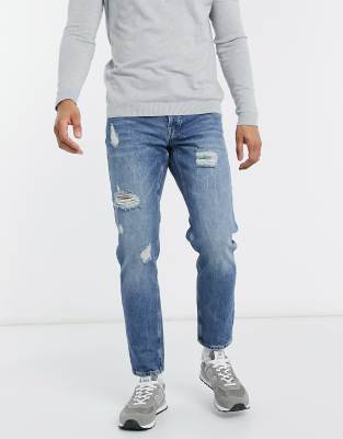 ASOS DESIGN tapered jeans in vintage mid wash blue with heavy rips - ASOS Price Checker