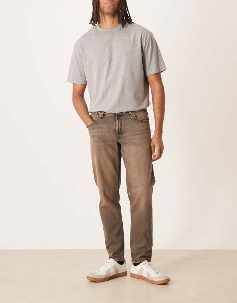 ASOS DESIGN tapered jeans in washed black with brown tint