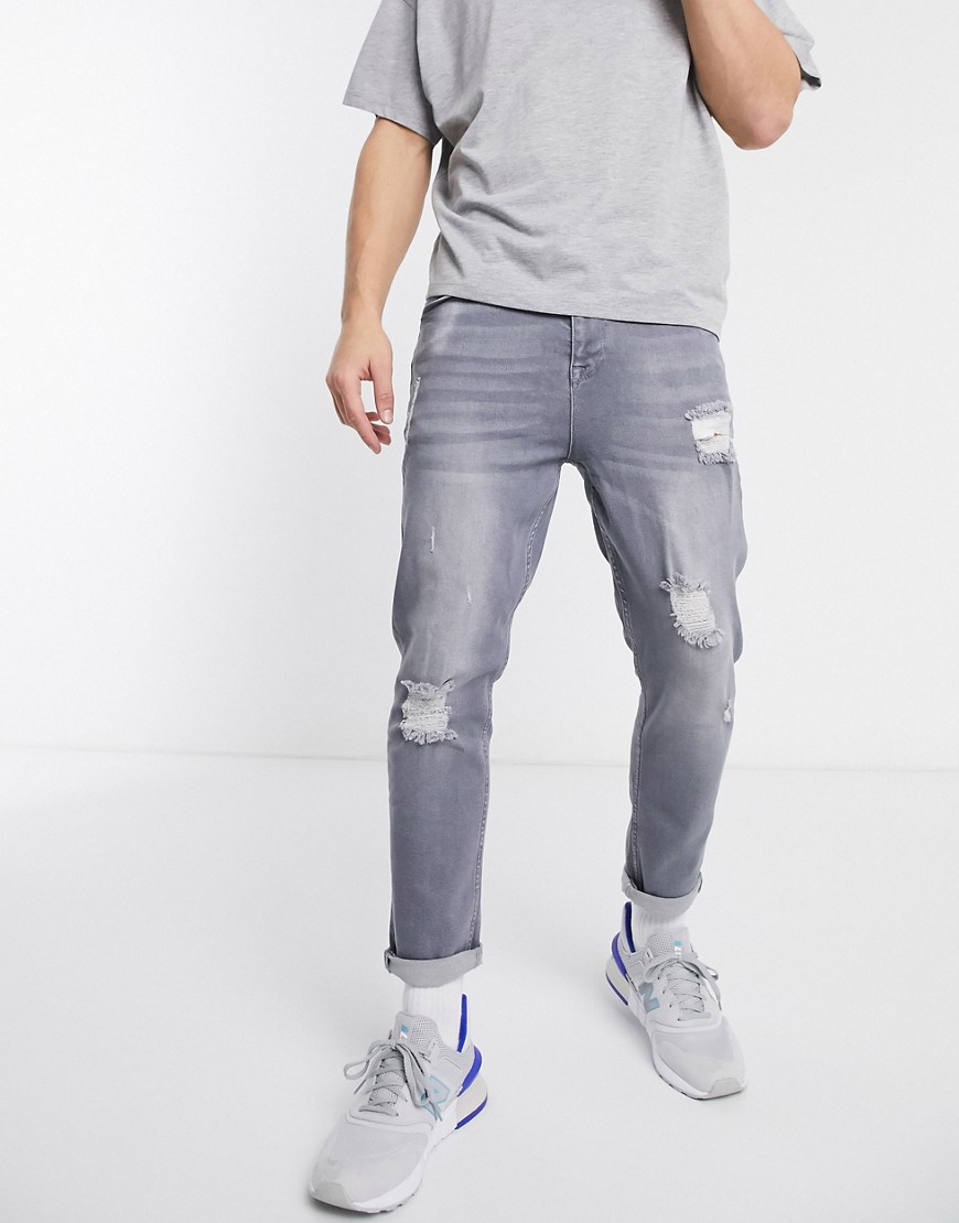 ASOS DESIGN tapered jeans in washed grey with abrasions