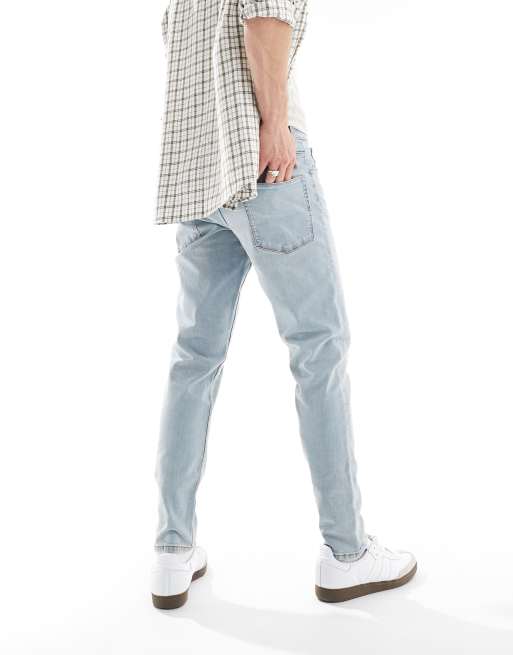 ASOS DESIGN tapered jeans with rips in light wash blue ASOS