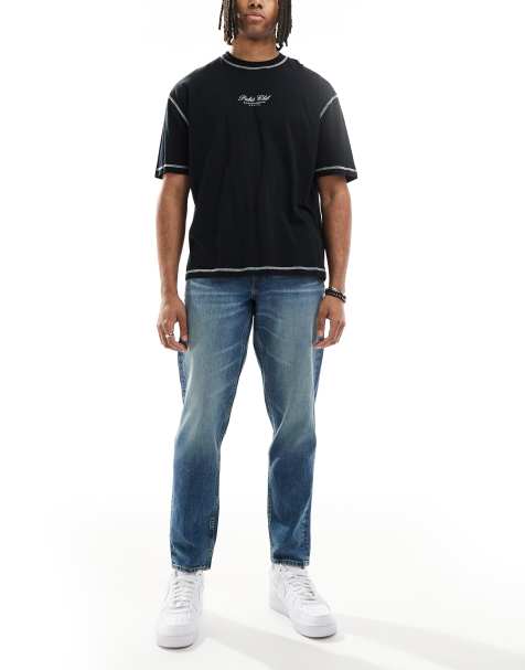 ASOS DESIGN tapered jeans with tint in dark wash blue - view 1