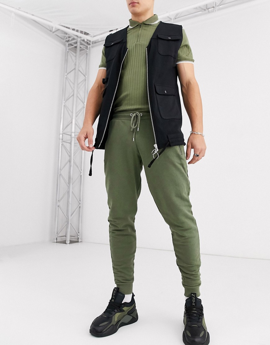 ASOS DESIGN tapered joggers in khaki with silver zip pockets-Green