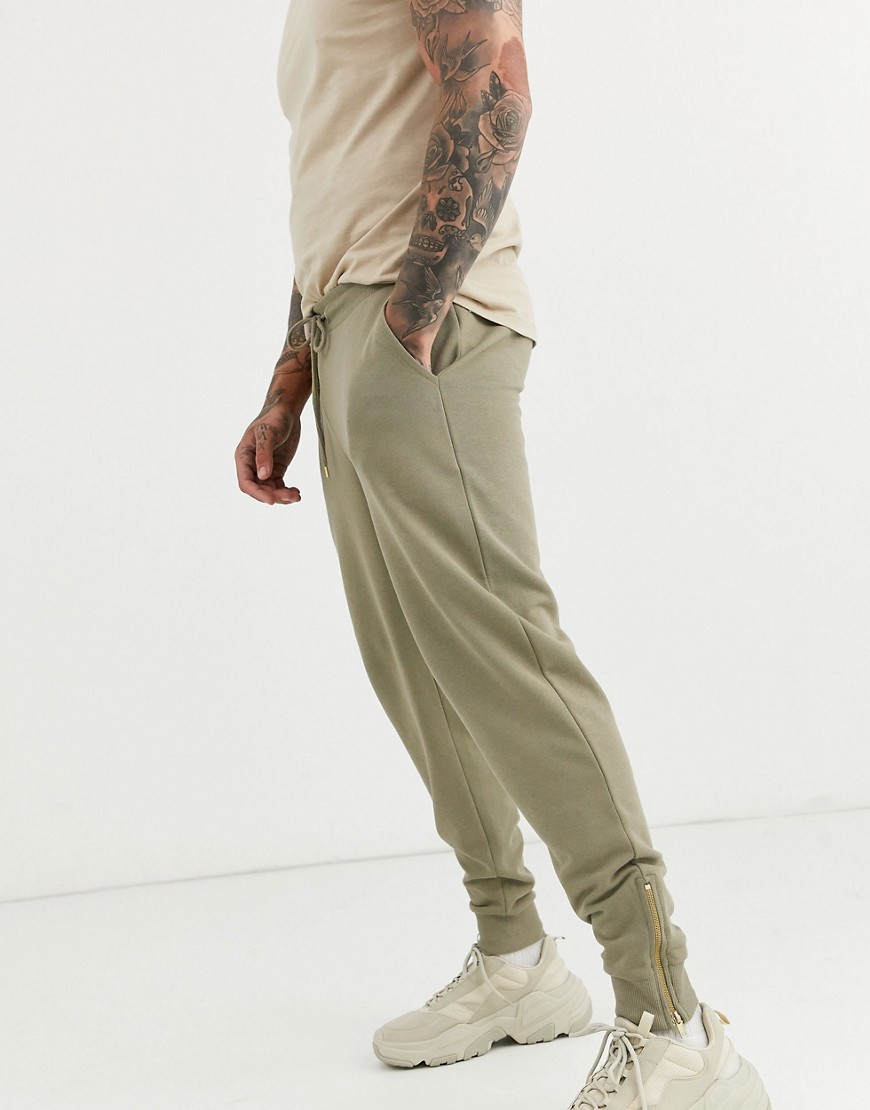 ASOS DESIGN tapered joggers in light khaki with gold zip cuffs-Green