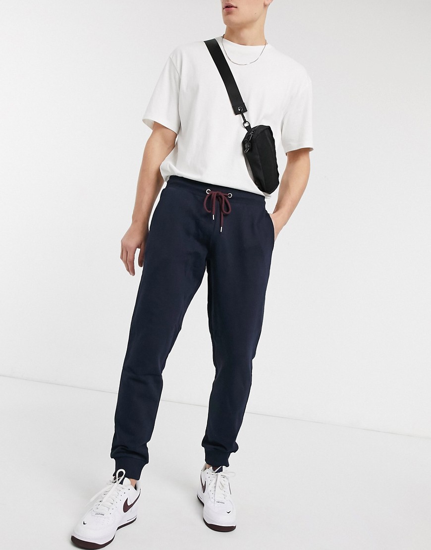 ASOS DESIGN tapered joggers in navy with red drawcords