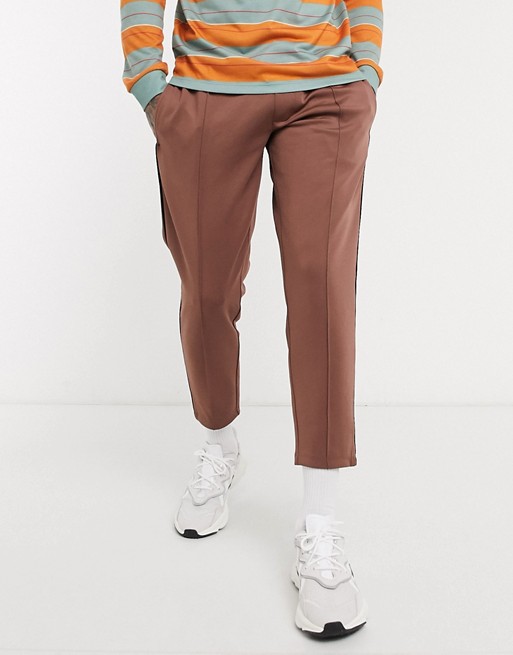 ASOS DESIGN tapered joggers in scuba fabric with pin tucks & piping in brown