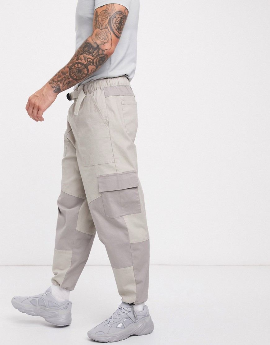 ASOS DESIGN tapered pants in cut and sew color blocking-Beige