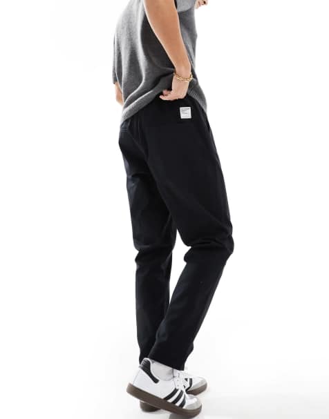 ASOS DESIGN tapered pull on pants in black with patch - view 1