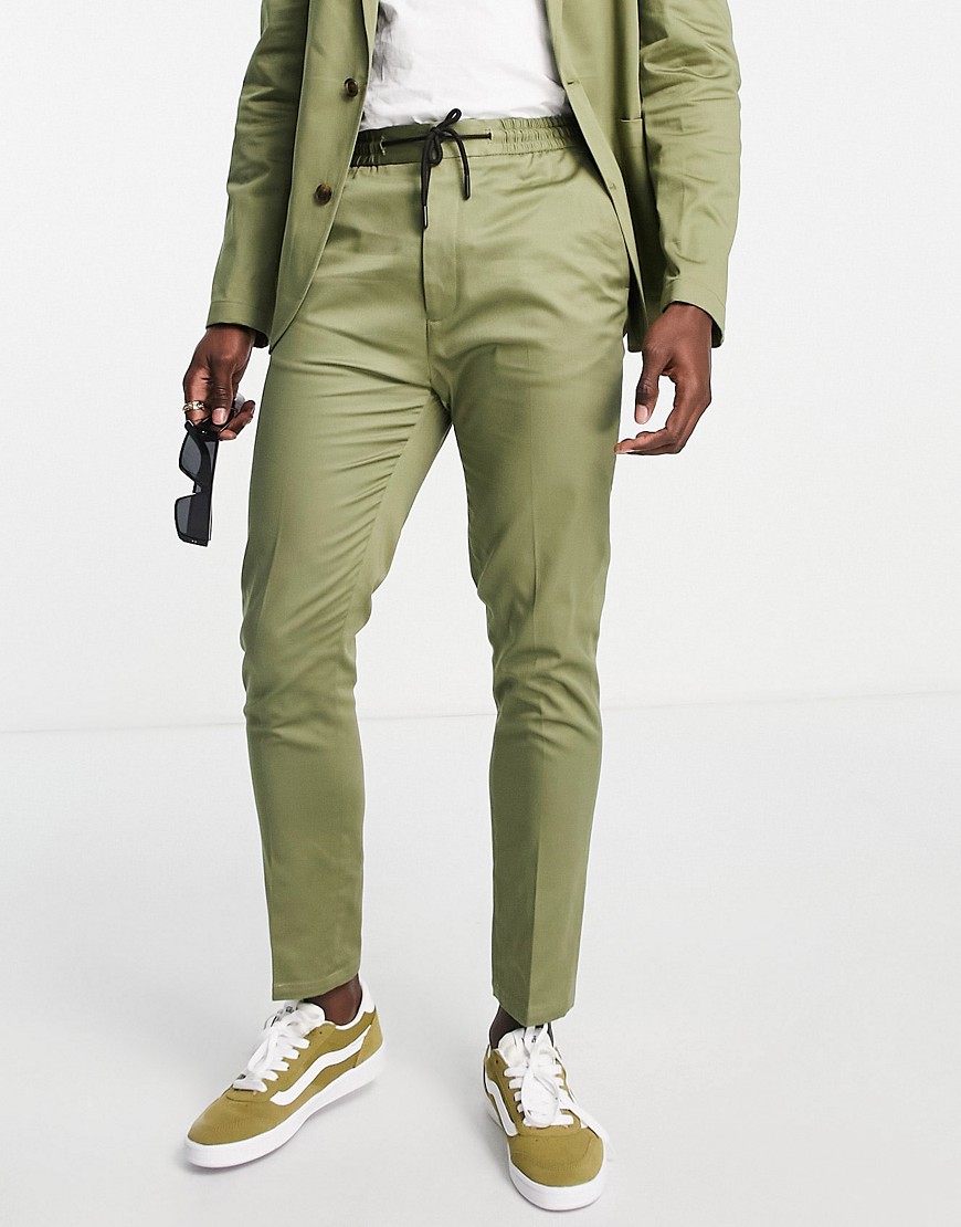 ASOS DESIGN tapered suit trousers with jogger waist and turn up in khaki green cotton