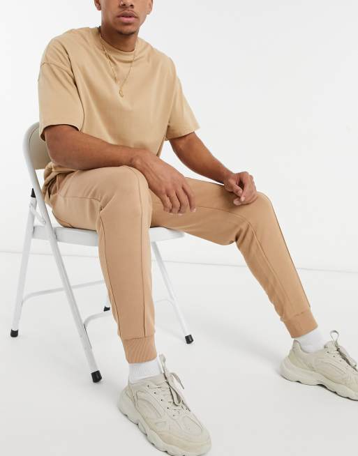 ASOS DESIGN tapered sweatpants with pin tuck in beige
