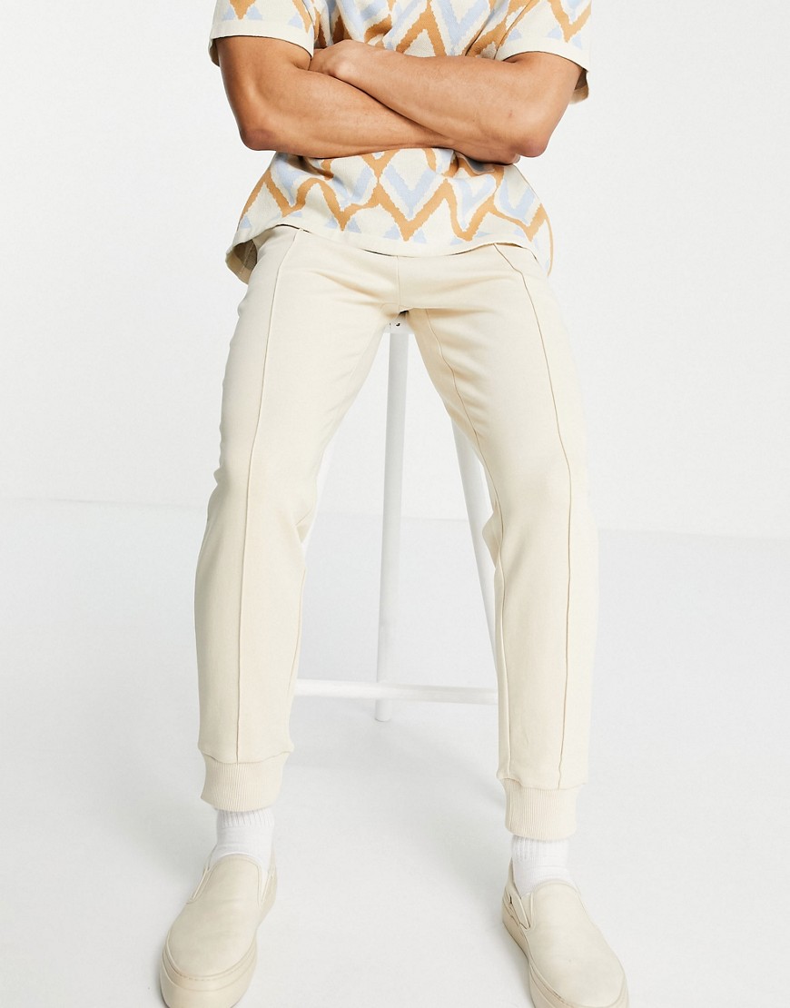 ASOS DESIGN tapered sweatpants with pin tuck in beige-Neutral