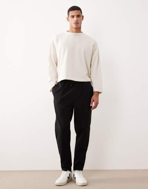 ASOS DESIGN tapered sweatpants with pin tuck in black - view 1
