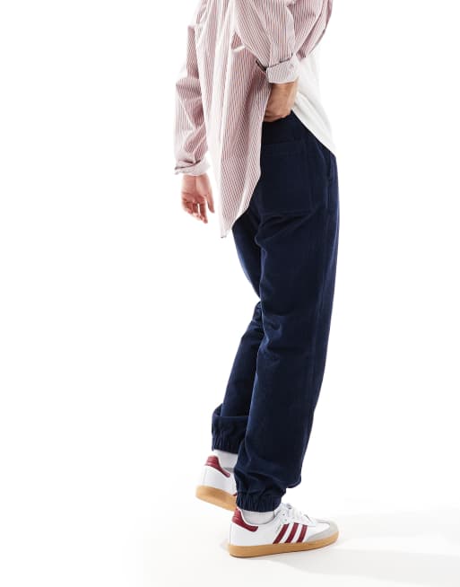 ASOS DESIGN tapered washed cord joggers in navy 