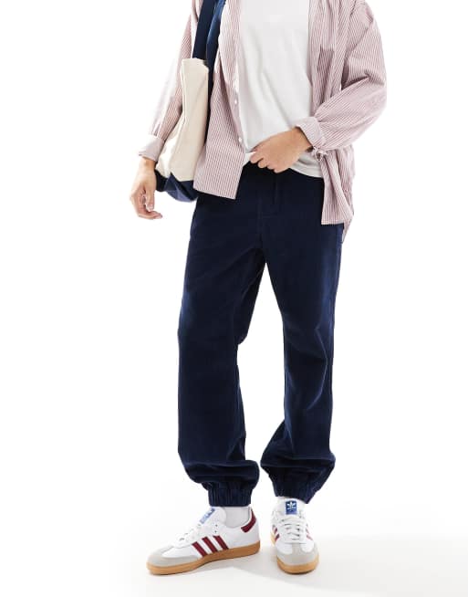 ASOS DESIGN tapered washed cord sweatpants in navy 