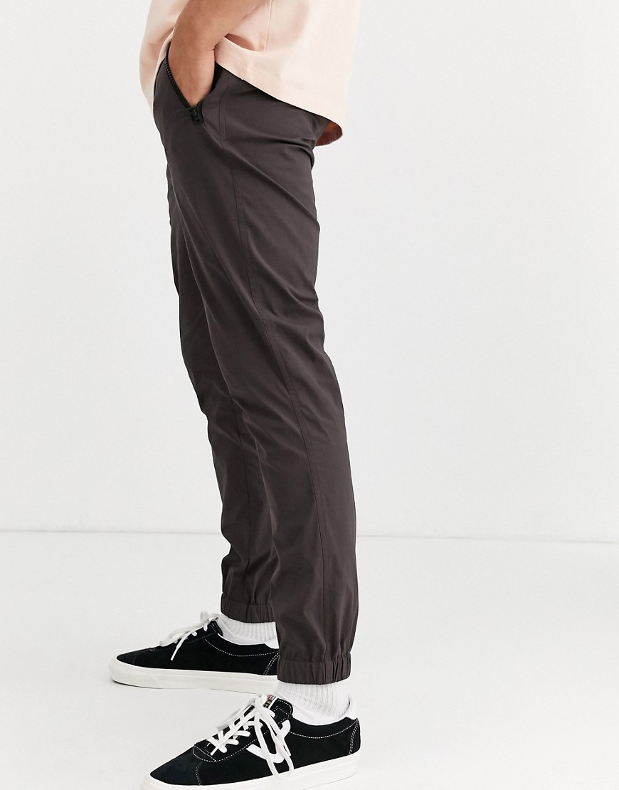ASOS DESIGN tapered woven joggers in nylon with webbed belt in brown