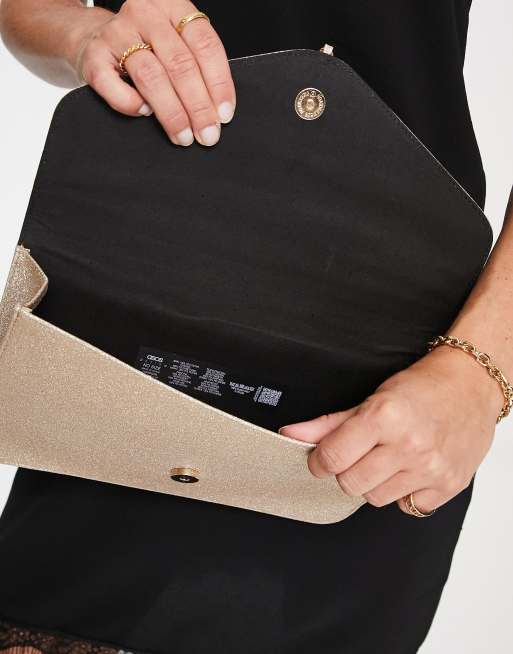 ASOS DESIGN tassel clutch bag in gold glitter