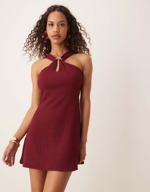 ASOS DESIGN textured halter cut out mini dress with hardware detail in burgundy