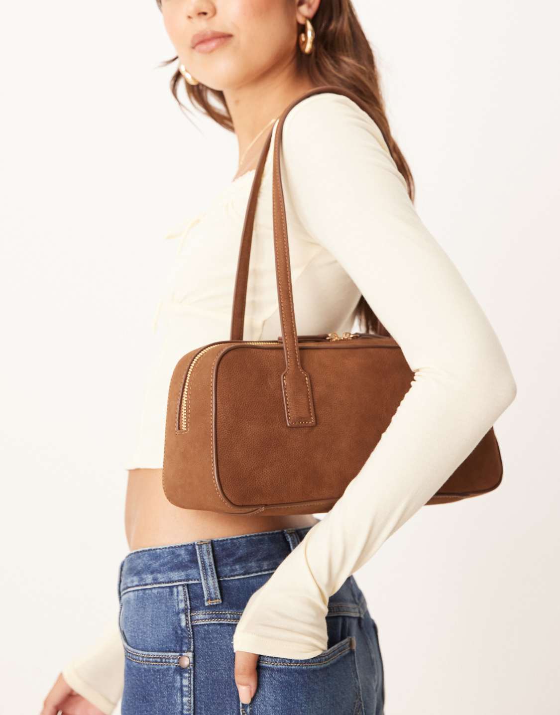 textured leather elongated bowler bag in tan