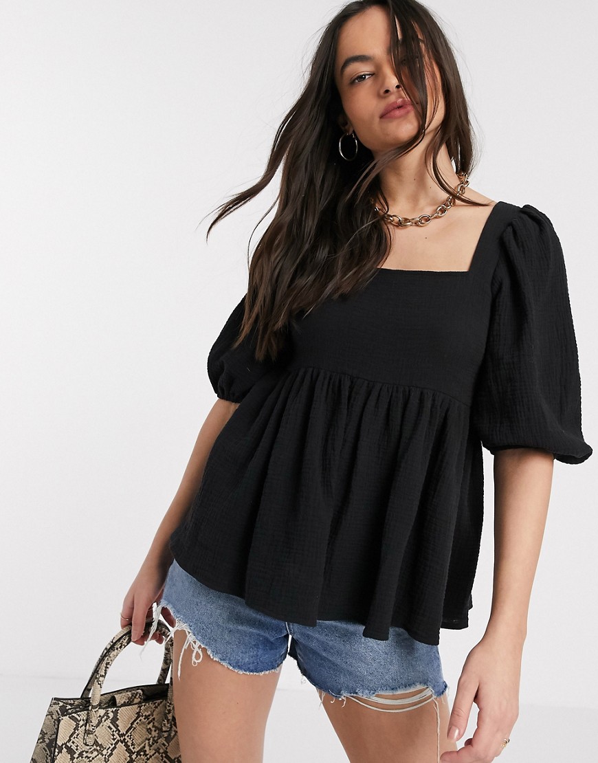 ASOS DESIGN textured peplum top with lace up back in Black