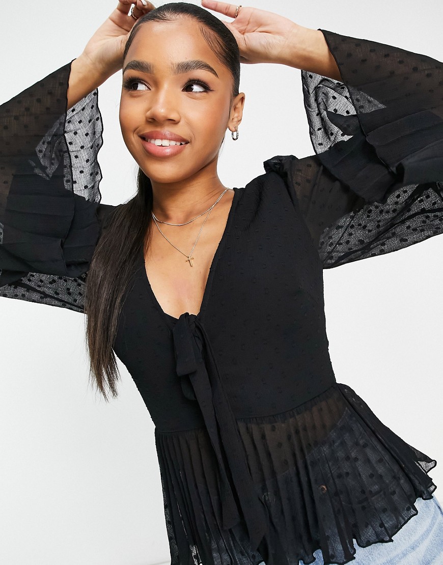 ASOS DESIGN textured pleated peplum top with button and tie detail with long sleeve in black