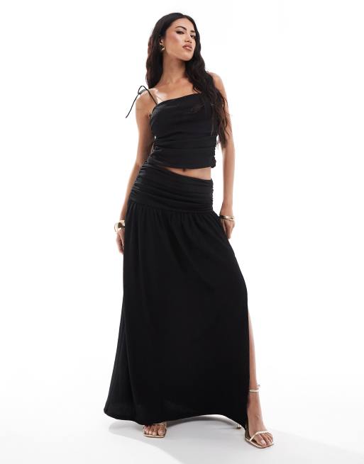 ASOS DESIGN textured ruched side drop waist maxi skirt with slit front in black (part of a set)