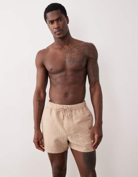 ASOS DESIGN textured swim shorts in short length in beige - view 1