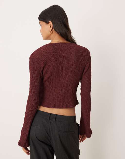 ASOS DESIGN textured tie front long sleeve top in burgundy