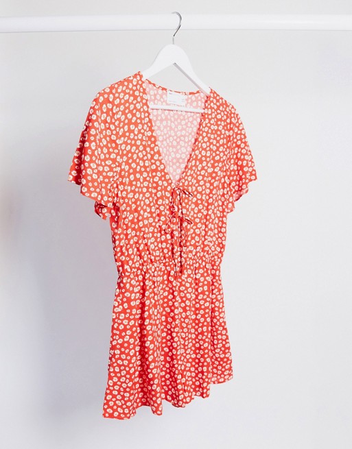 ASOS DESIGN tie front playsuit in red daisy print