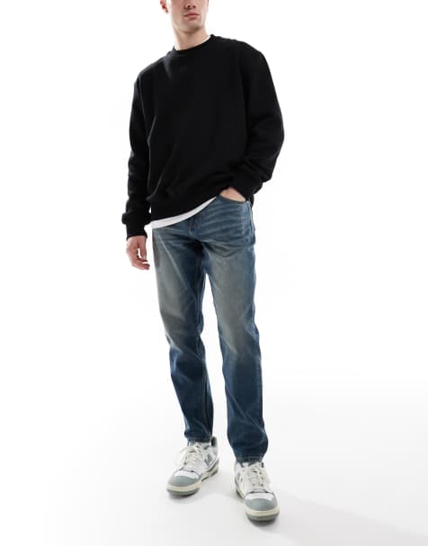 ASOS DESIGN - Toelopende jeans in blauw met donkere vintage wassing - view 1