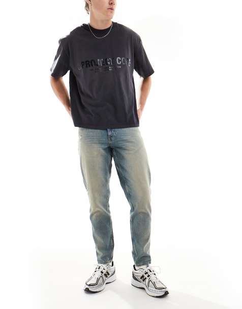 ASOS DESIGN - Toelopende jeans met tint in lichtblauwe wassing - view 1