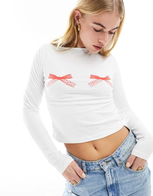 ASOS DESIGN - Top a maniche lunghe color avorio con stampa di fiocchi