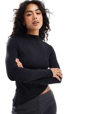 ASOS DESIGN - Top a maniche lunghe nero in poliammide con fondo asimmetrico