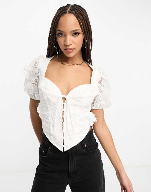 ASOS DESIGN - Top corset à manches bouffantes et à nouer devant en dentelle florale 3D - Blanc