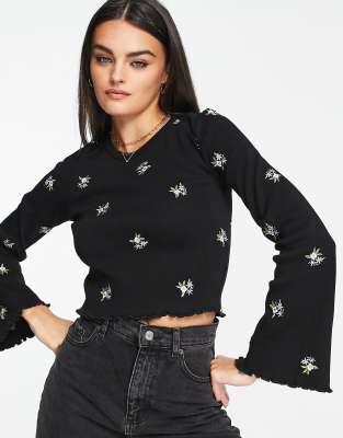 ASOS DESIGN - Top nervuré à manches évasées et fleurs brodées - Noir  | ASOS