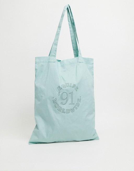 ASOS DESIGN tote bag in pastel green with collegiate print