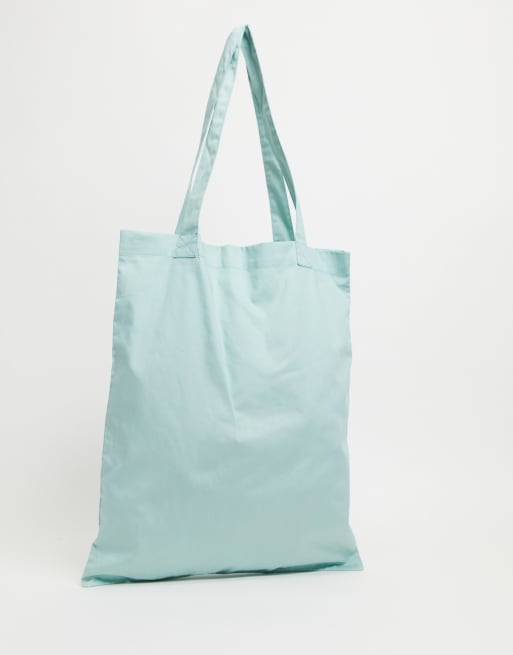 ASOS DESIGN tote bag in pastel green with collegiate print