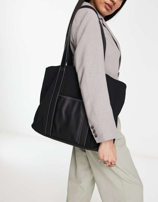 ASOS DESIGN tote with center pocket in black with white top stitch