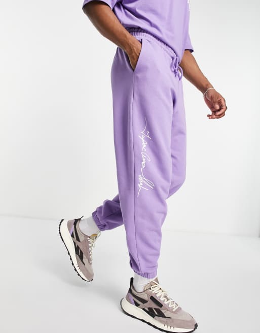 ASOS DESIGN trackies with Tupac prints in purple (Part of a set)