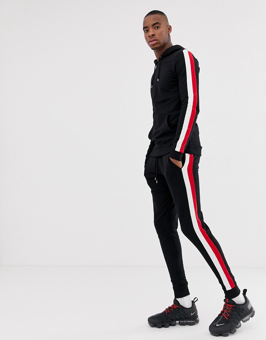 ASOS DESIGN tracksuit muscle hoodie/super skinny joggers in black with side stripe