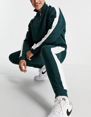 ASOS DESIGN tracksuit oversized half zip track top/ tapered joggers with side stripe in deep green