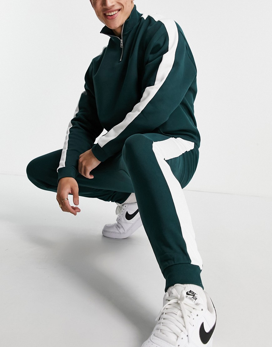 ASOS DESIGN tracksuit oversized half zip track top/ tapered sweatpants with side stripe in deep green