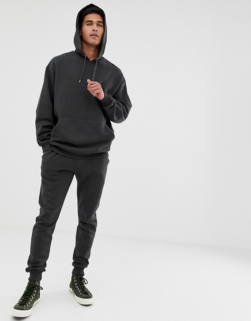 ASOS DESIGN tracksuit oversized hoodie / skinny joggers in washed black ...