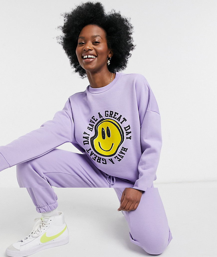 ASOS DESIGN tracksuit oversized sweatshirt / oversized sweatpants with happy face graphic in lilac-Purple