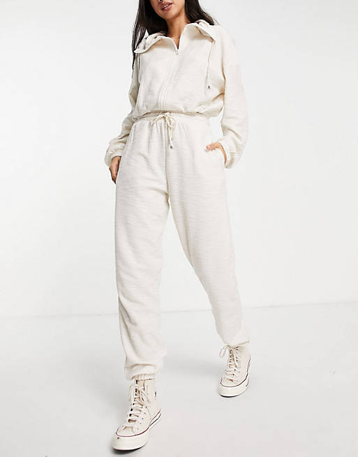 Women tracksuit with funnel neck and jogger in slouchy texture in cream 