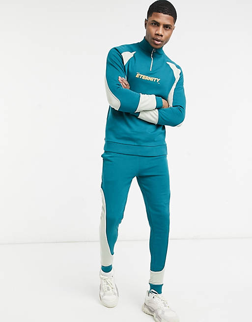 ASOS DESIGN tracksuit with half zip in colour block panels & chest ...