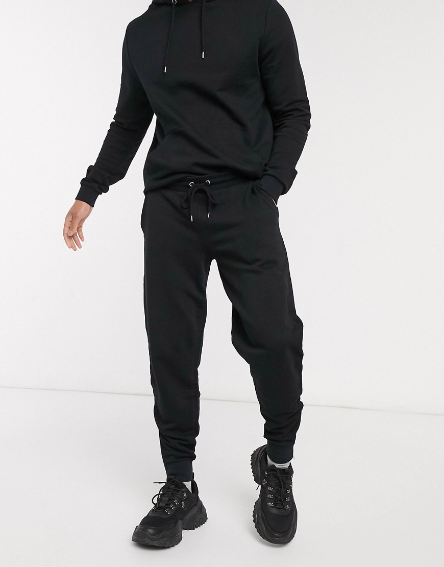 ASOS DESIGN tracksuit with hoodie & joggers with silver zip in black