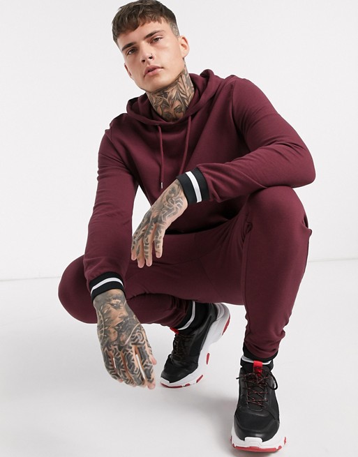ASOS DESIGN tracksuit with hoodie & striped rib in burgundy