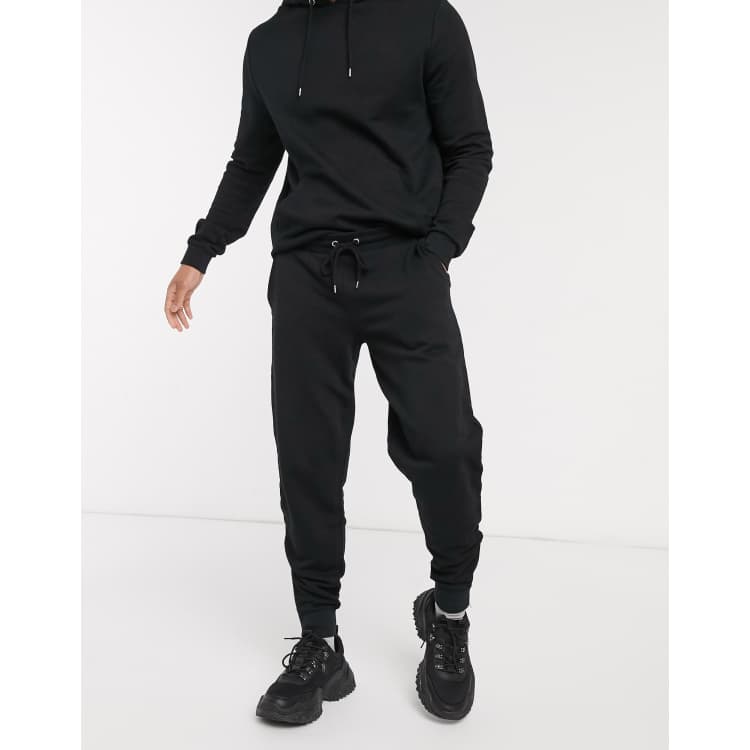 ASOS DESIGN tracksuit with hoodie sweatpants with silver zip in black