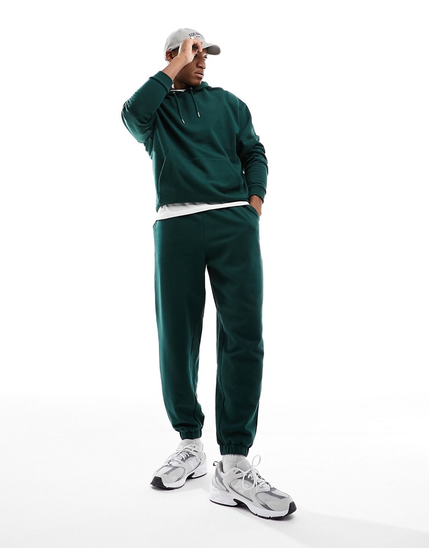 ASOS DESIGN tracksuit with oversized hoodie and jogger in dark green
