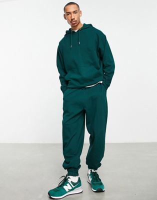ASOS DESIGN tracksuit with oversized hoodie and oversized joggers in dark green